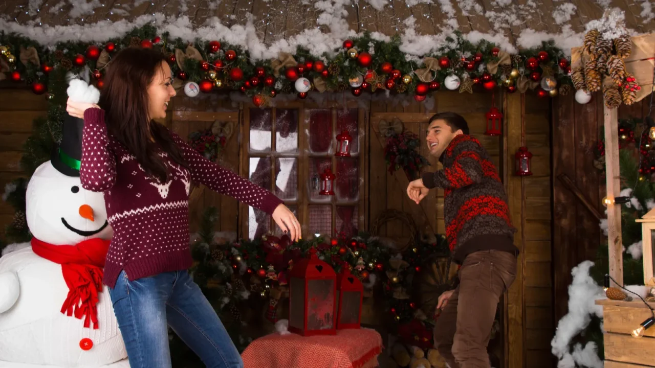 woman throwing cotton snow to a guy while playing