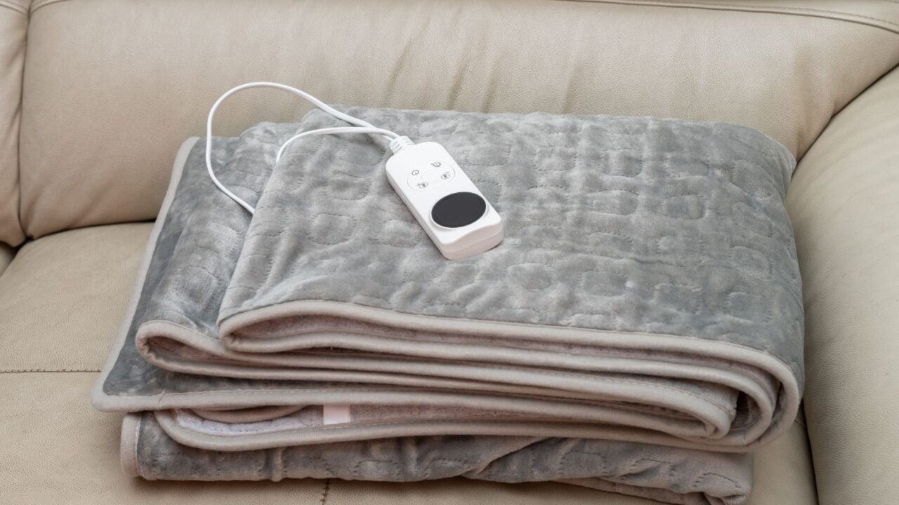 A cozy gray electric throw blanket on the couch.