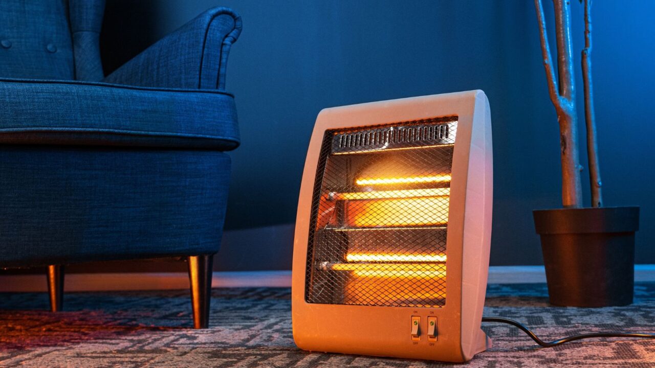 An electric infrared heater on a rug in a living room.