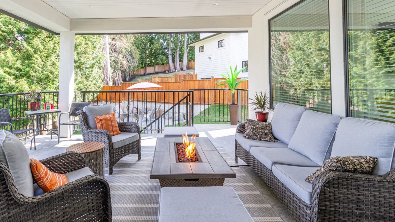 A firepit table heater with furniture around it on a patio.