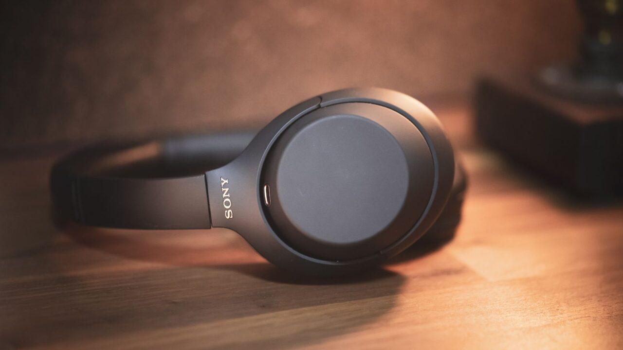 Sony wireless noise cancelling headphones on a wooden surface.