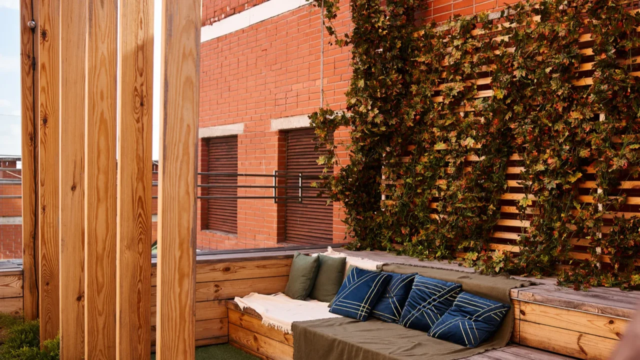 a cozy couch placed on a wooden deck surrounded by