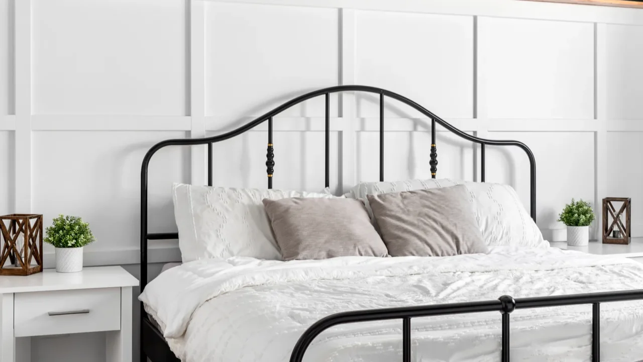 a farmhouse bedroom detail shot with wainscoting decorations on a