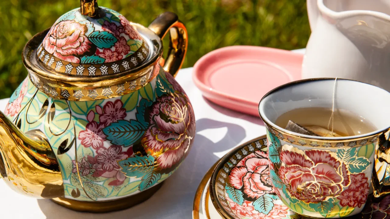 a luxurious tea set with a golden floral teapot and