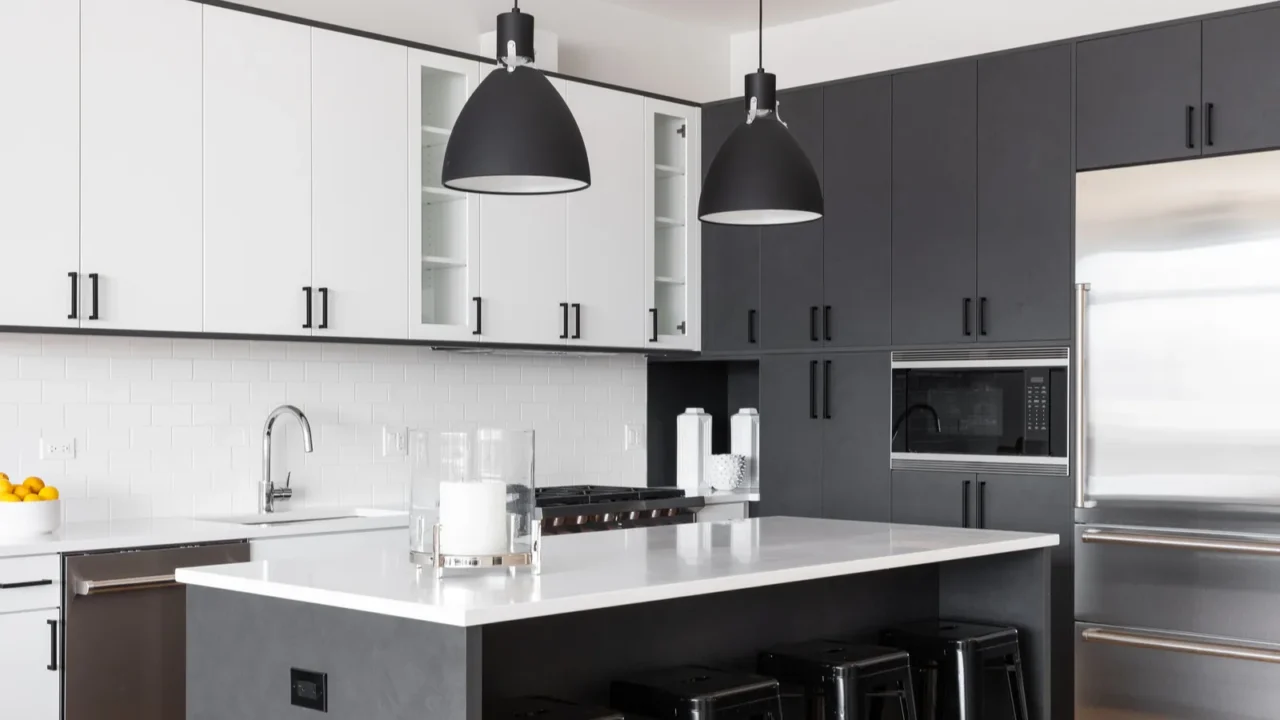 a modern kitchen with white and black cabinets bar stools