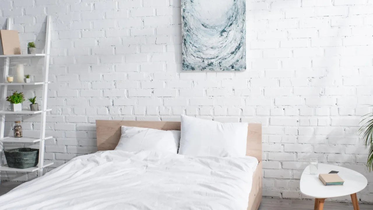 bed with white bedding in modern bedroom