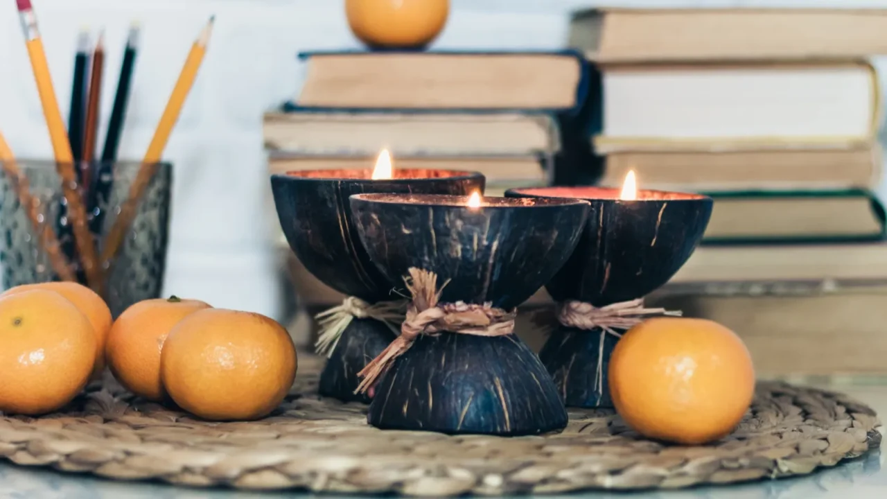 burning spa aroma candles in coconut shell tangerines on wicker