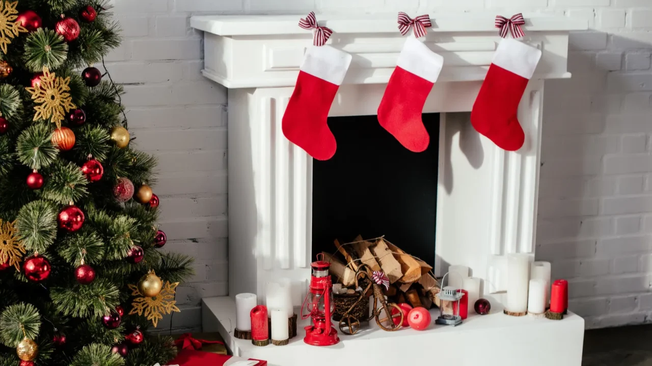 christmas tree with baubles gift boxes and fireplace with christmas