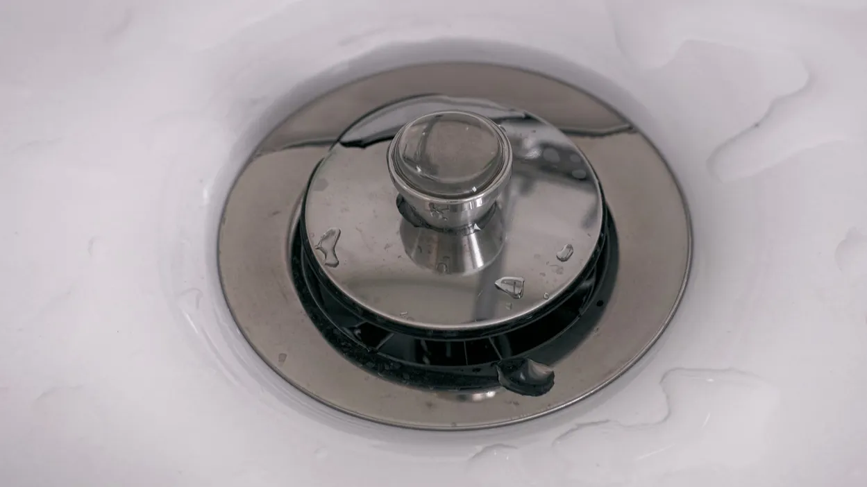 closeup of sink drain with stopper