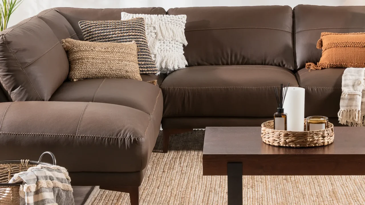 cozy living room featuring a brown leather sectional sofa with