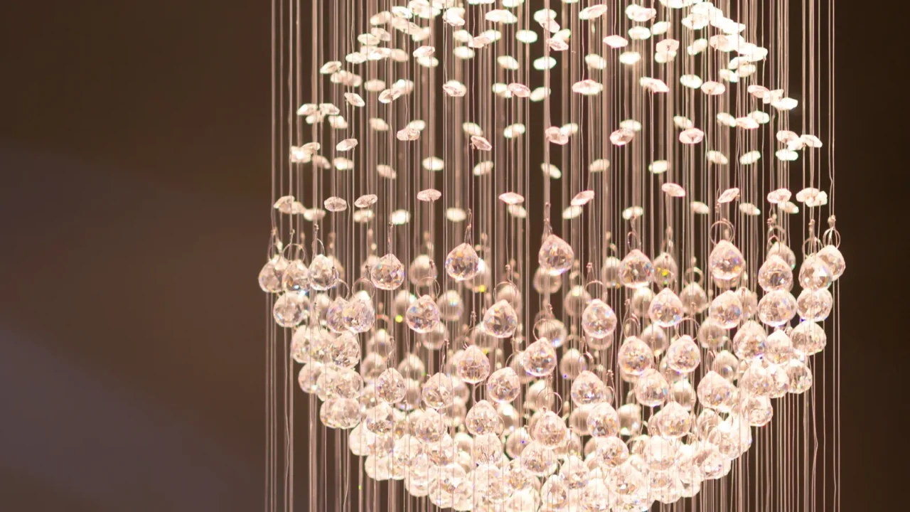 A stunning crystal chandelier made of numerous glass droplets, creating an eye-catching centerpiece in a modern space.