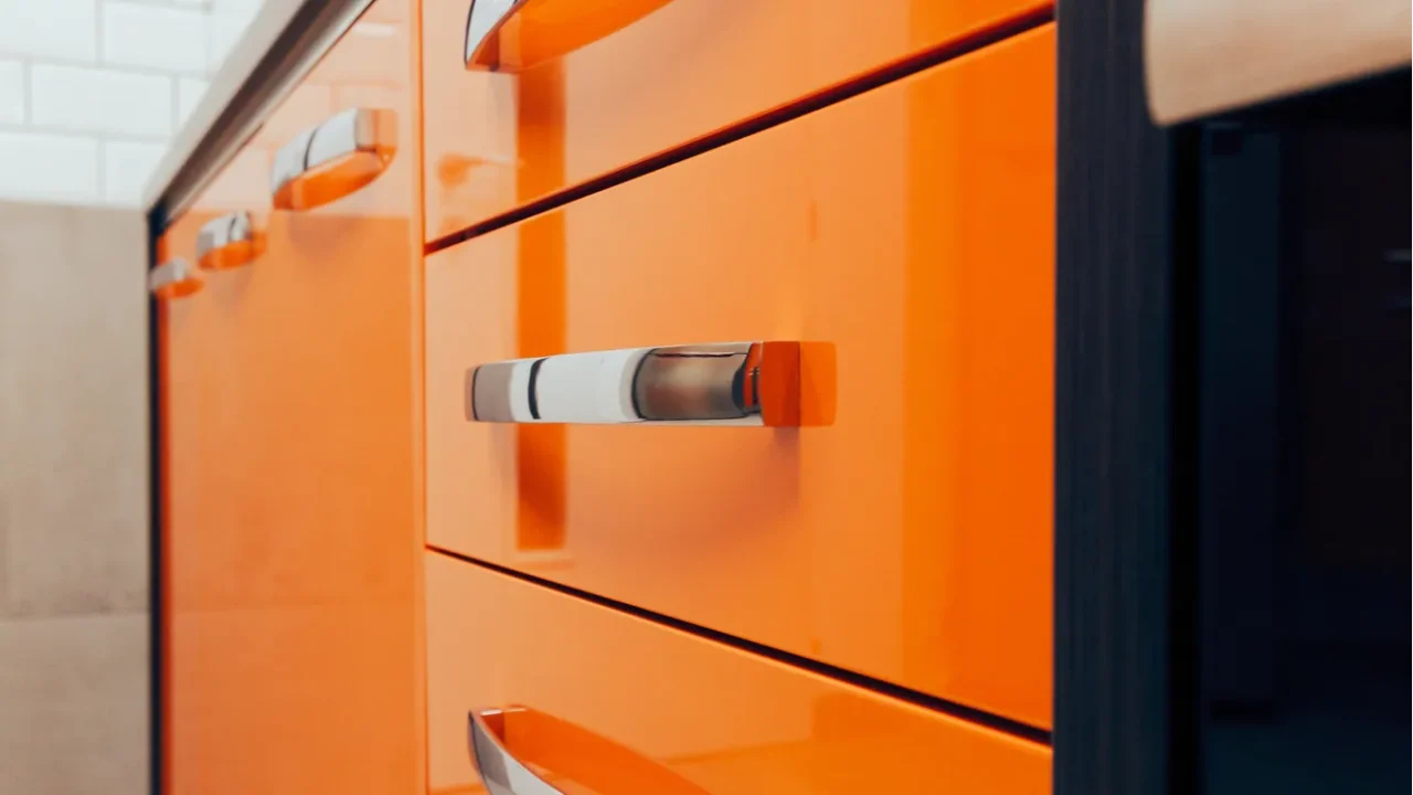 detail of orange kitchen drawers great for cooking utensil storage