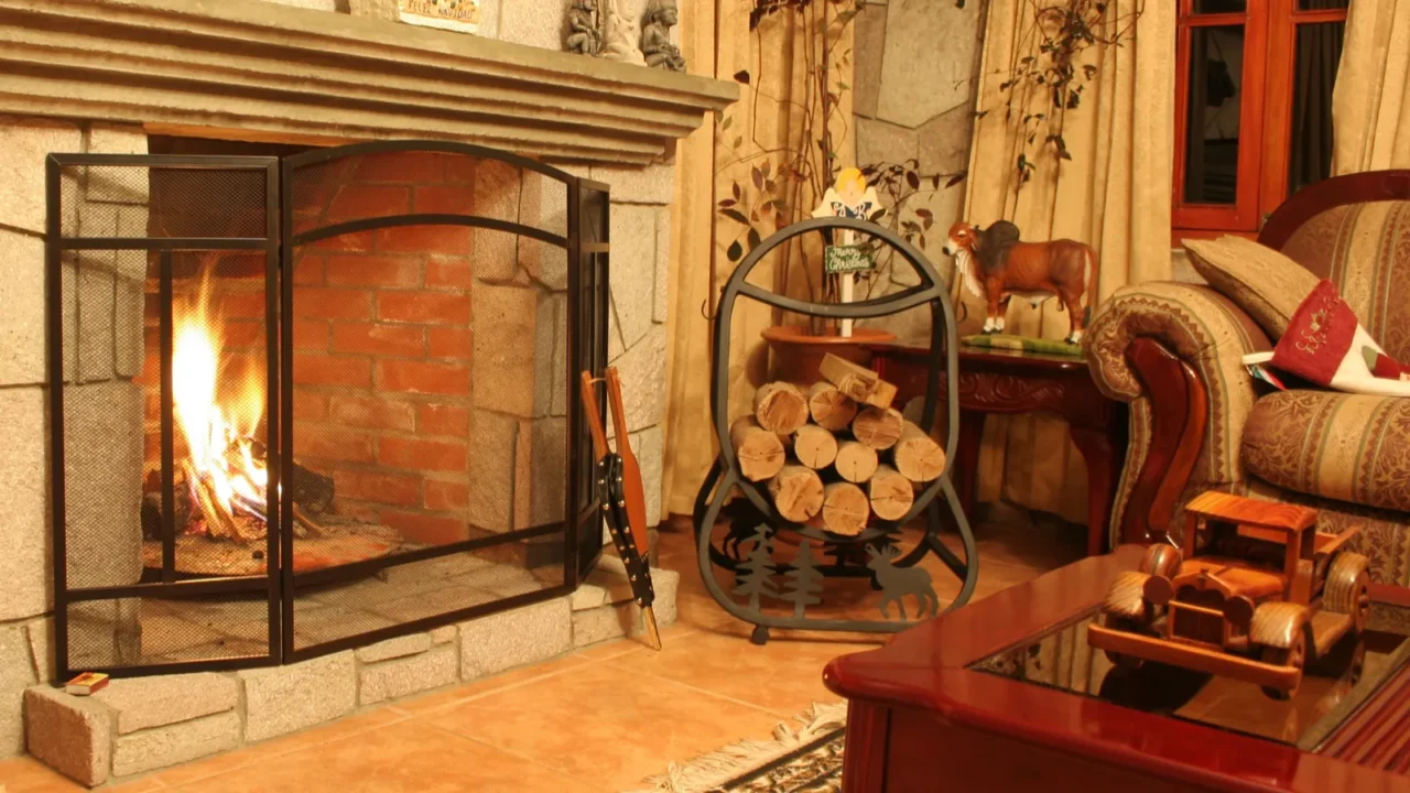 Fireplace in a cozy living room with wrought iron fireplace screen.