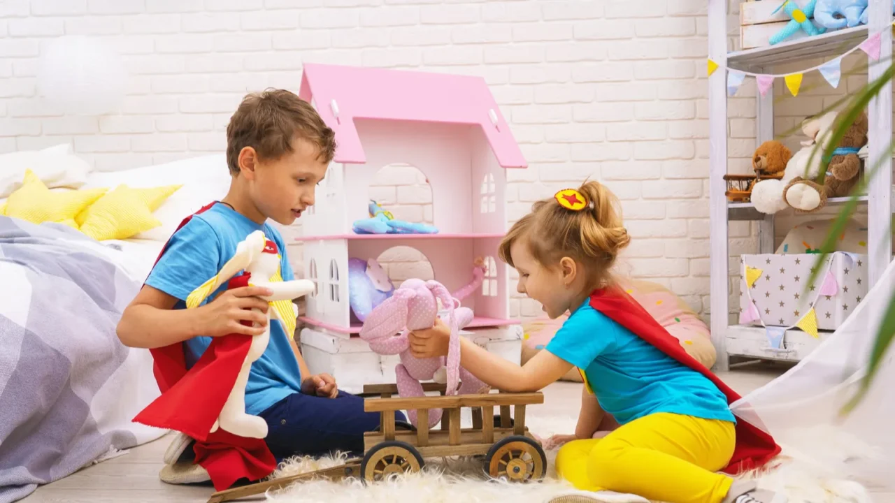 funny children play with toys in superheroes in children room