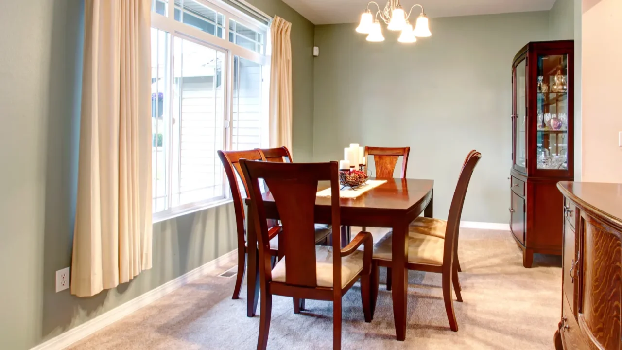 green dining room interior with classic brown furniture