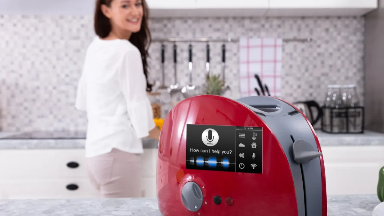 happy woman looking at red toaster with voice recognition function