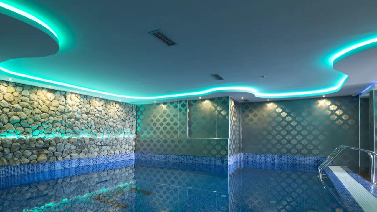 indoors pool with colorful lights at spa center