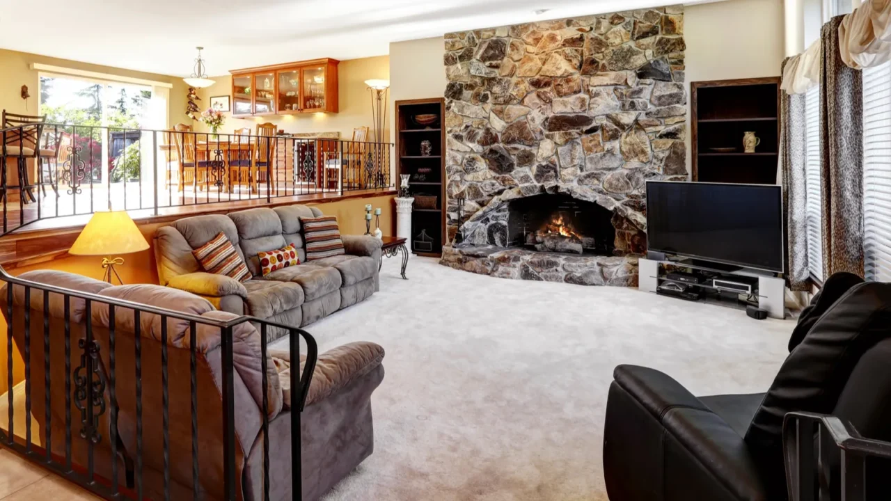 luxury open living room interior with stone fireplace