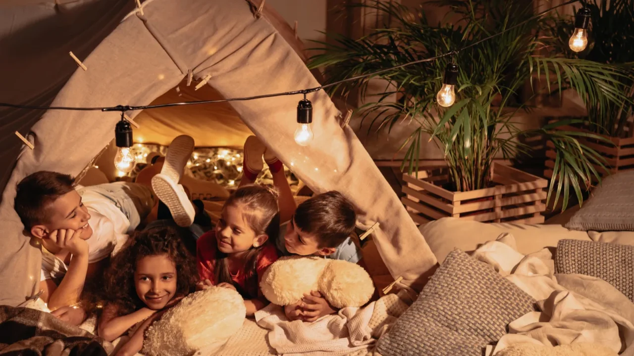 multiethnic children resting in tent