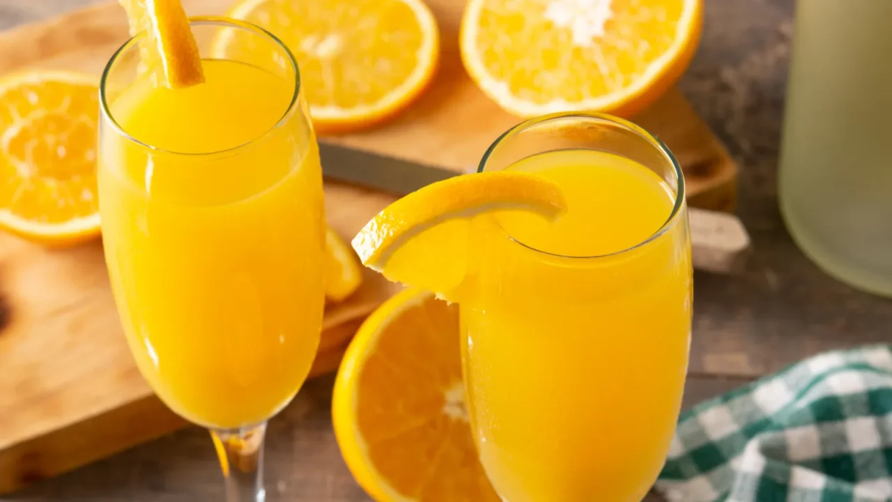 orange mimosa cocktail on wooden table