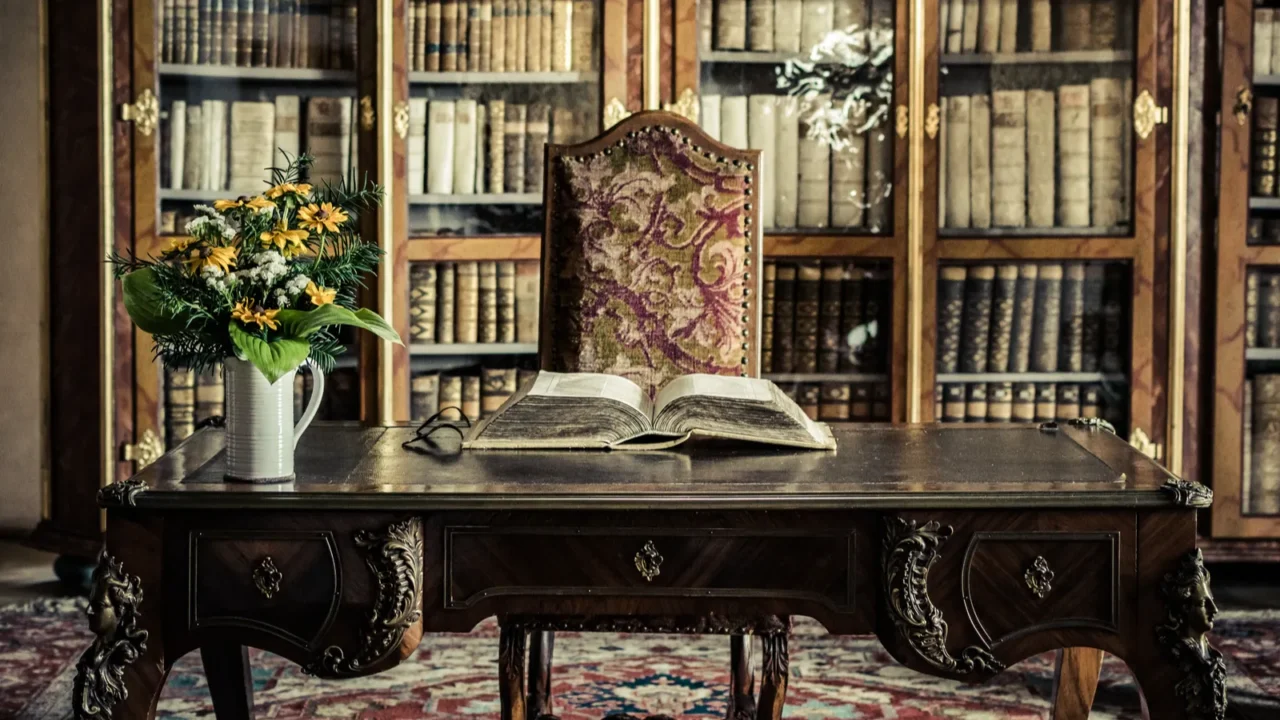 picture of a table with a book and flowers in