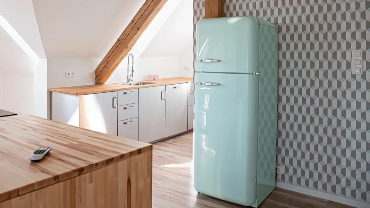 retro refrigerator in bright attic kitchen in loft apartment