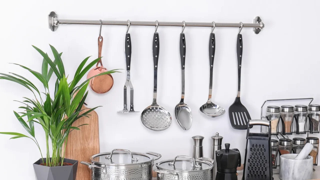 set of clean cookware dishes utensils and appliance on table