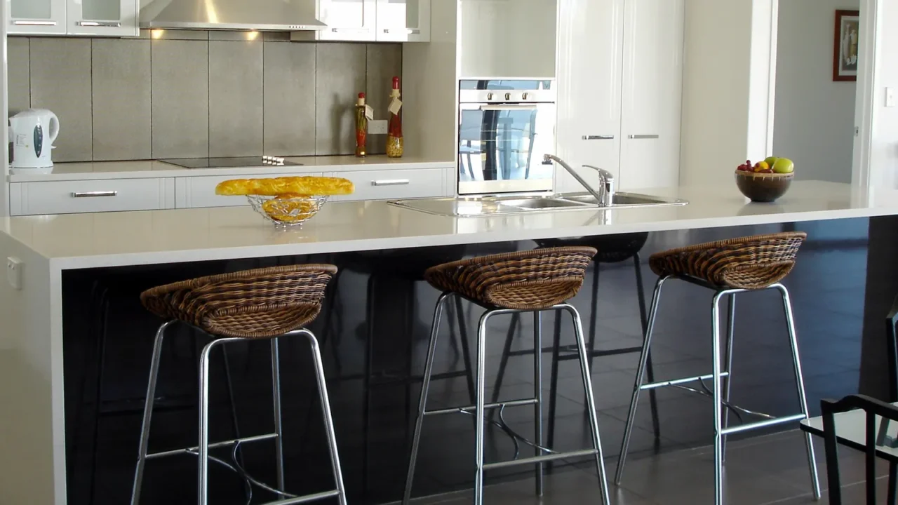 spacious white open plan kitchen with breakfast bar