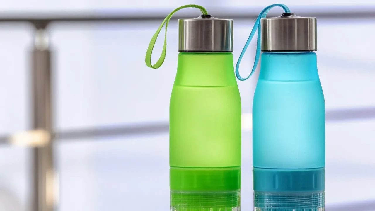 sports water bottles on table against blurred background space for