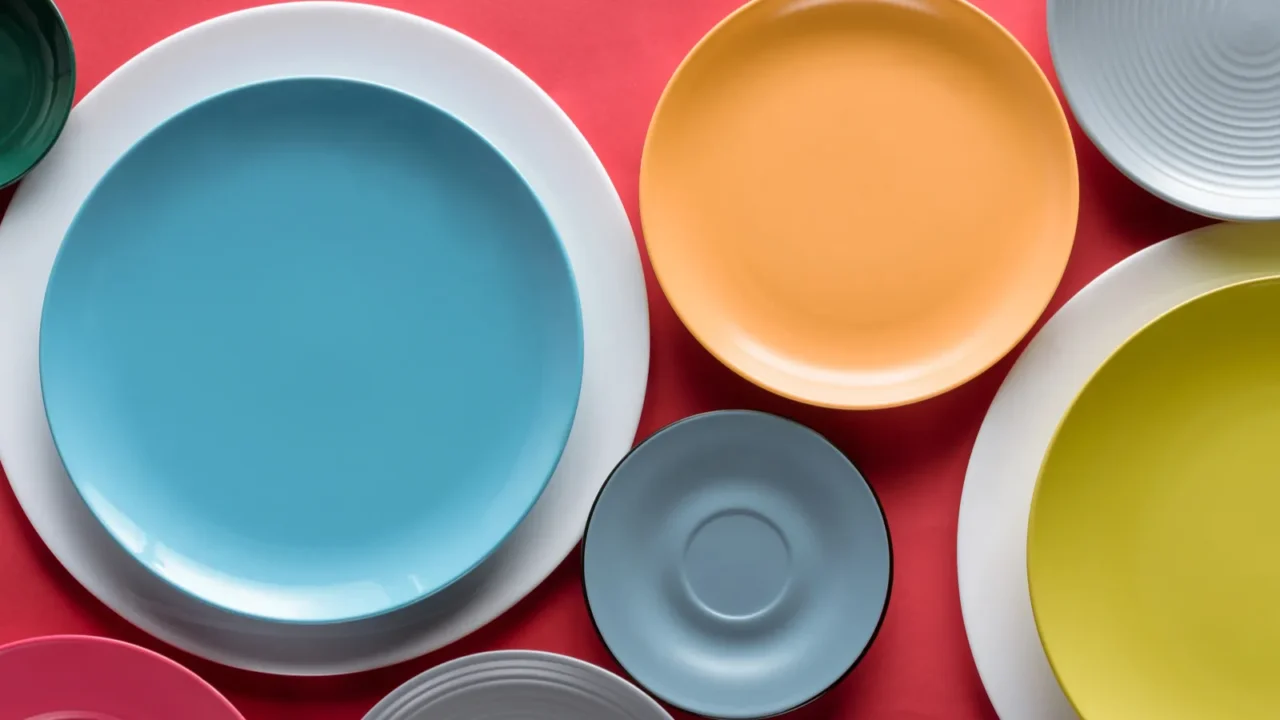 stacks of colorful porcelain plates on red background