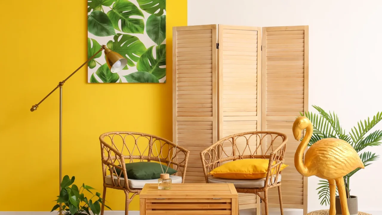 stylish interior of room with wicker chairs and golden flamingo