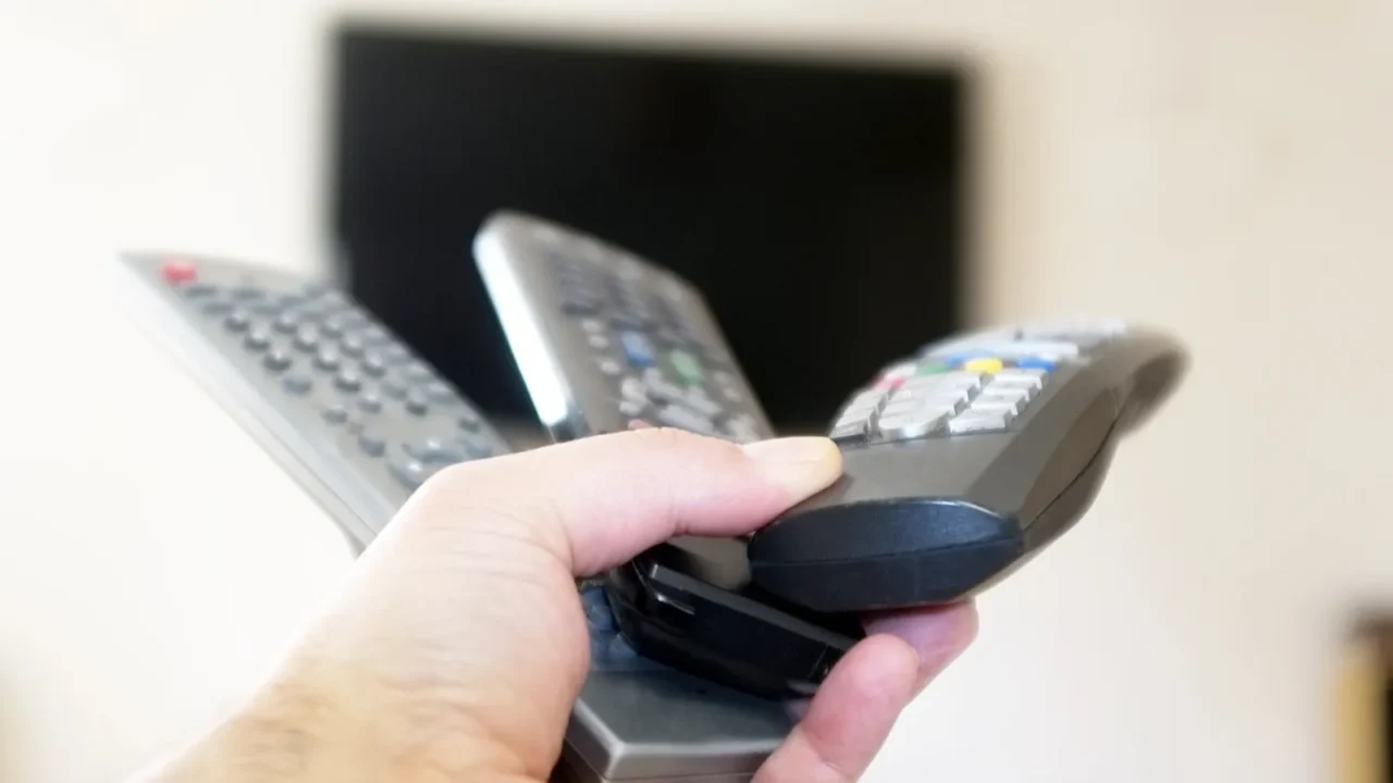 three remote controls in one hand