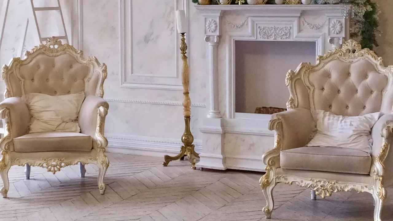 two beige vintage chairs with golden stucco in the interior