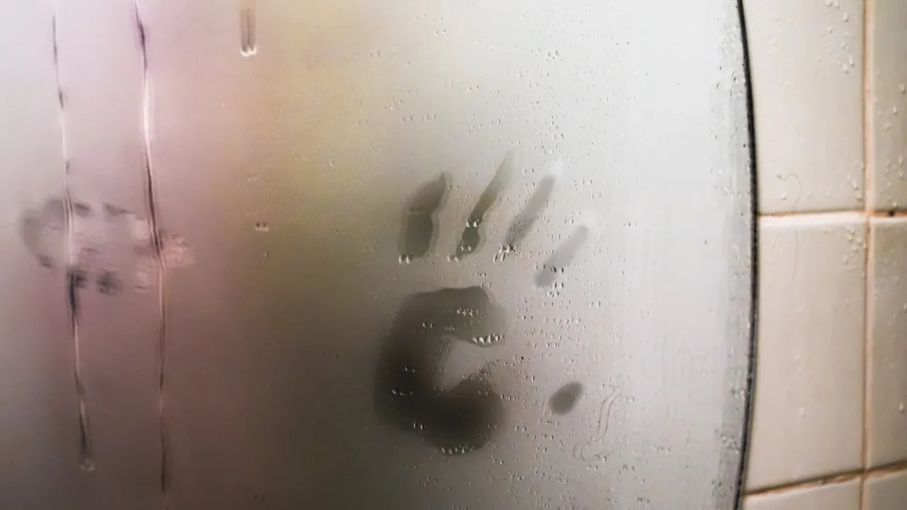 wet foggedup mirror with handprint