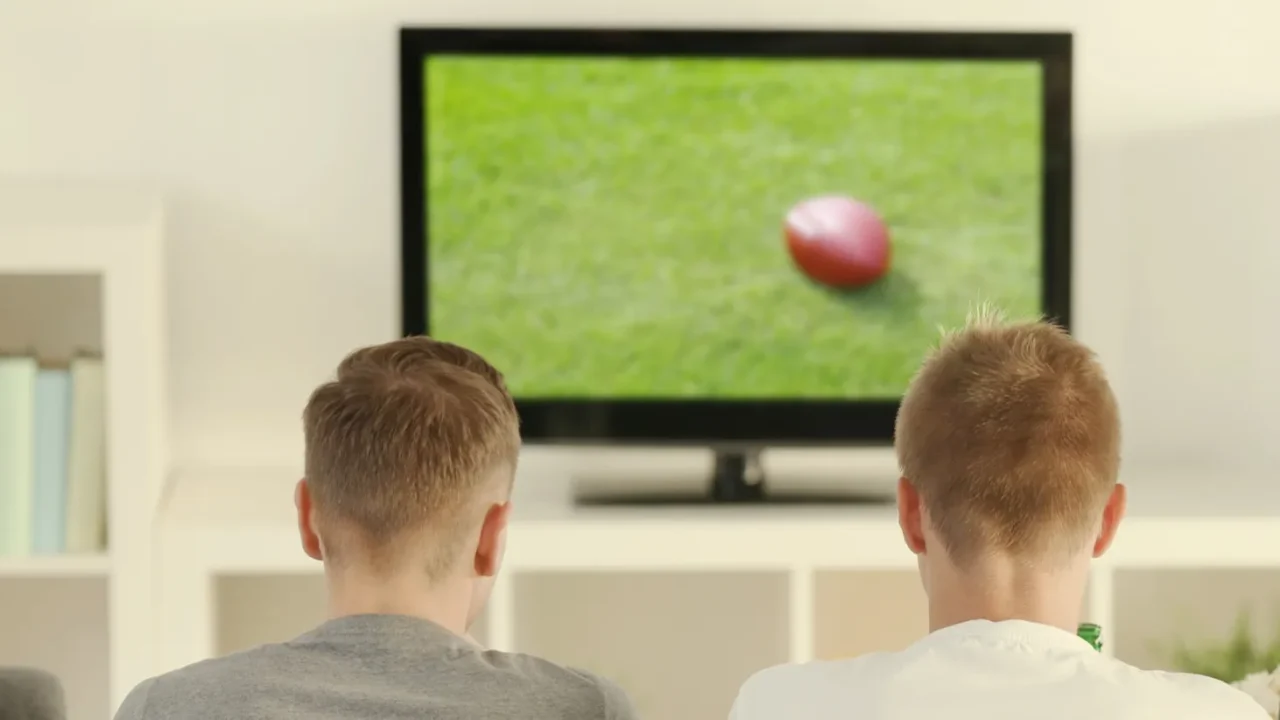 young fans watching sports on tv