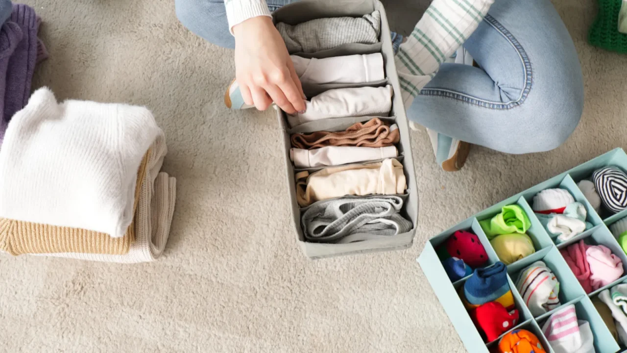 young woman organizing clothes at home