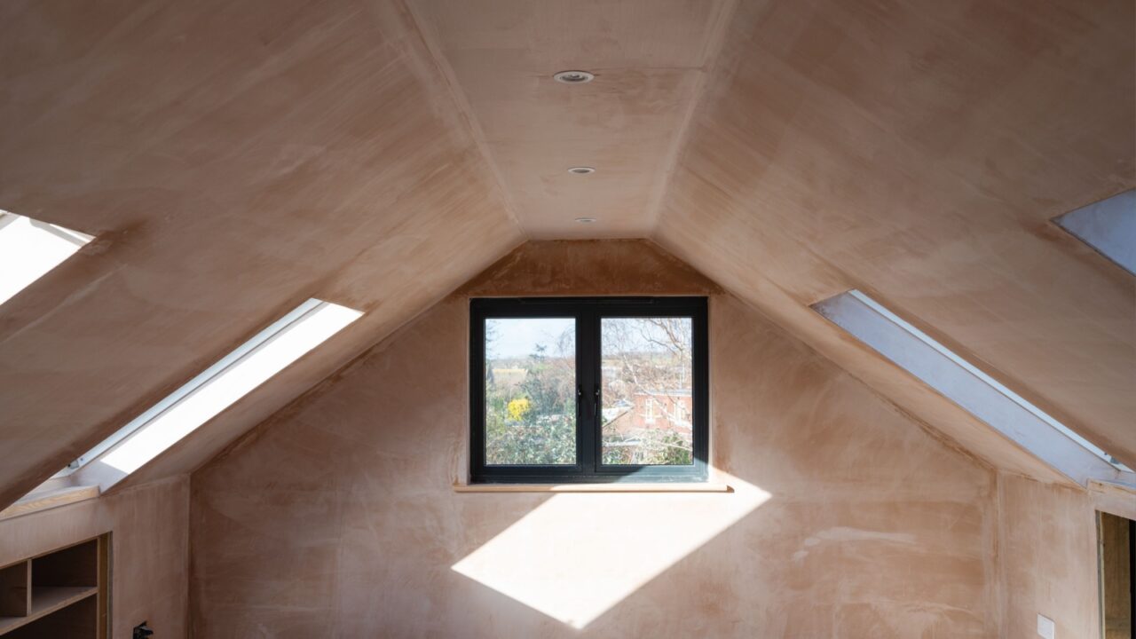 An angled view of a bright room with a window and natural light.