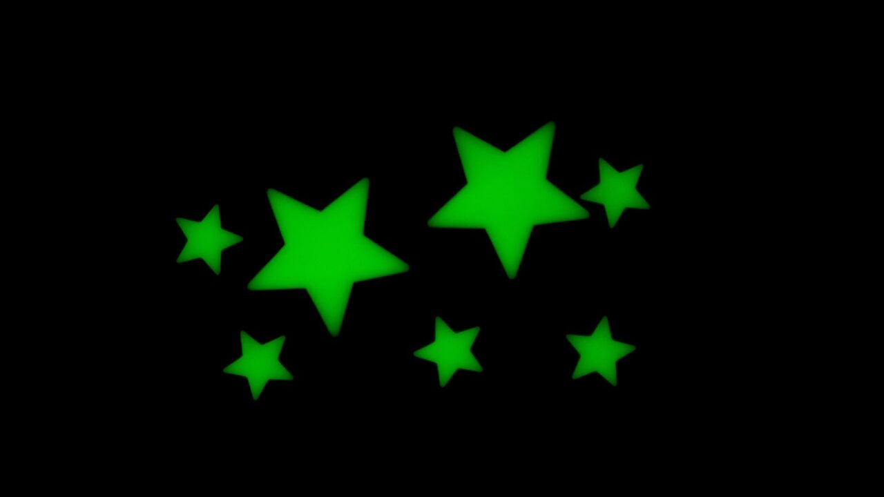 Green glow in the dark stars on a black background.