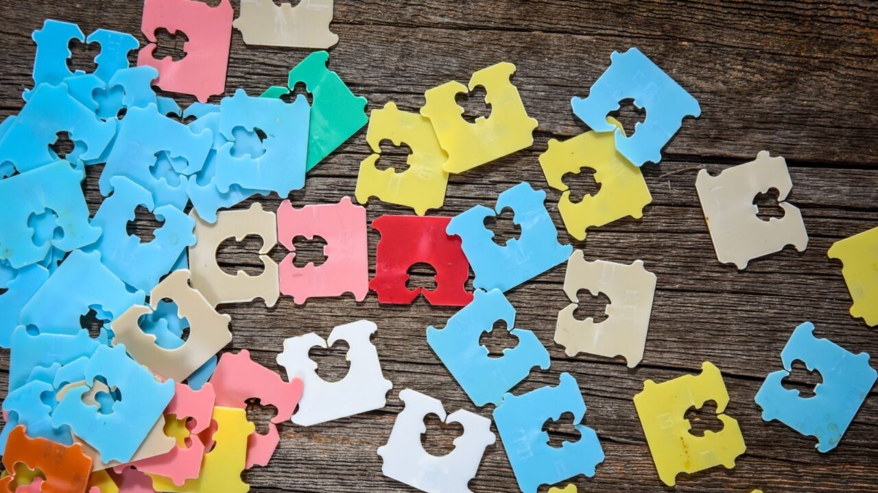 Colorful bread tabs on a wooden surface.