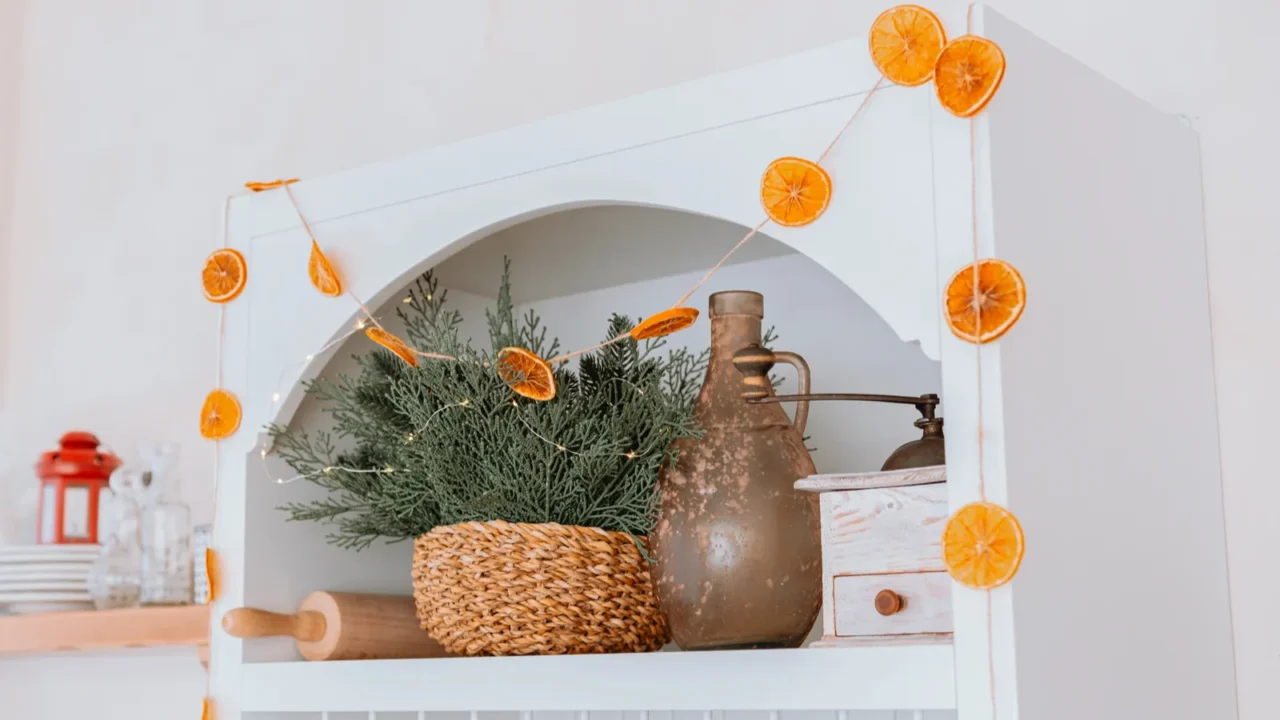 a bright room features a decorative shelf adorned with dried