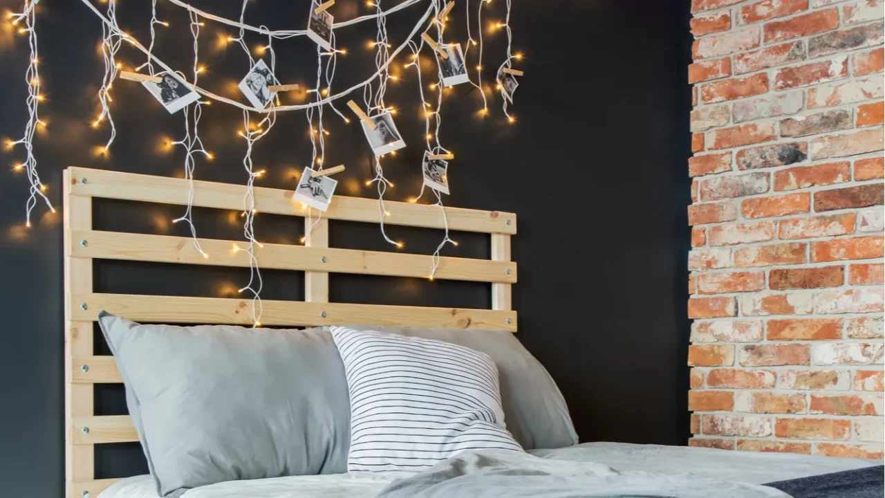 bed with decoration next to brick wall