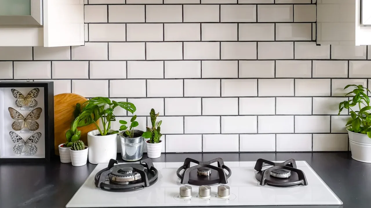 black and white subway tiled kitchen with numerous plants and