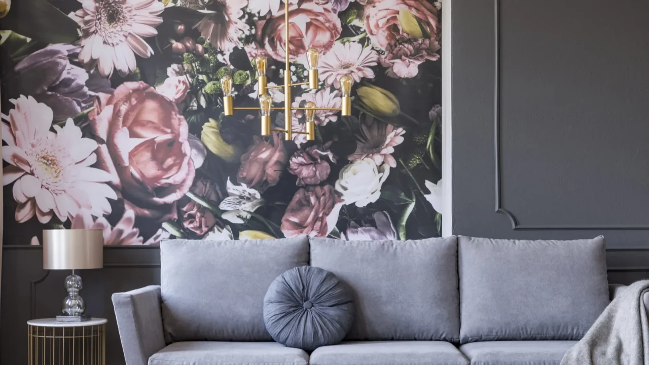 blanket on grey couch in living room interior with flowers