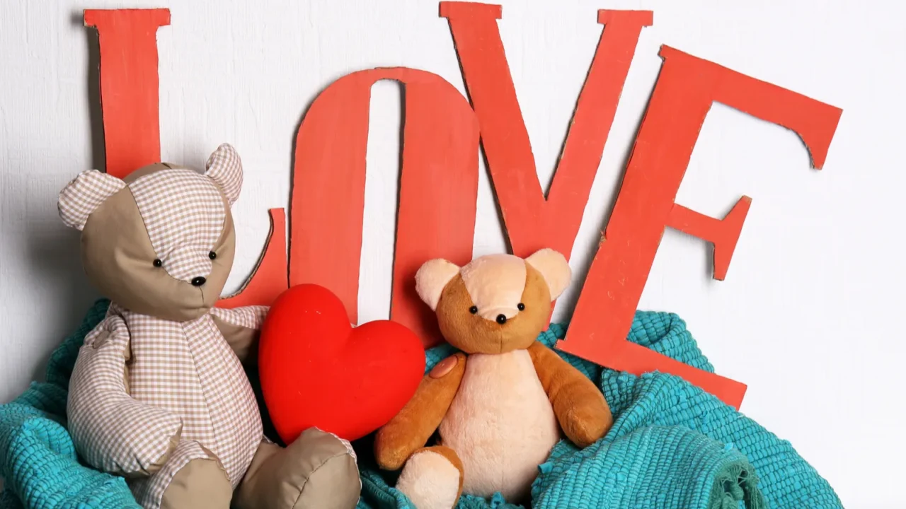 decorative letters forming word love with teddy bear on wall