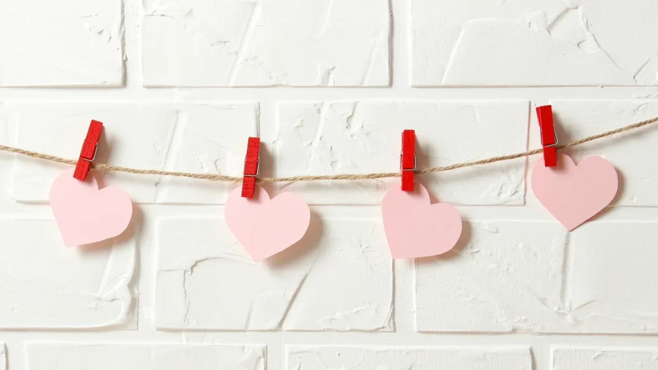 hearts on a thread on a colored background garland of