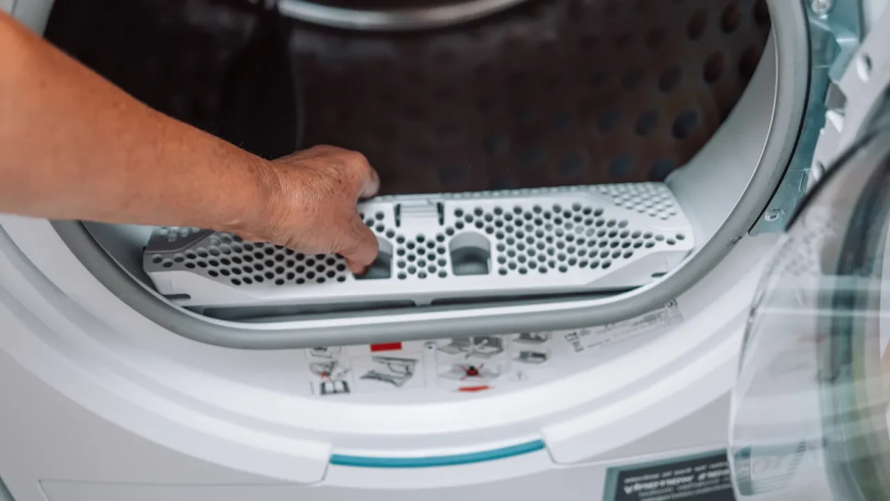 horizontal photo of female hand taking the lint out from