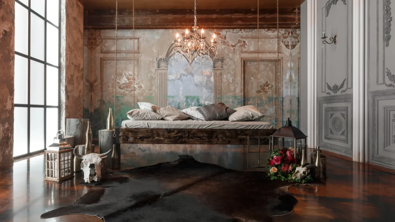 A unique bedroom with a hanging bed, vintage decor, and a rustic chandelier.