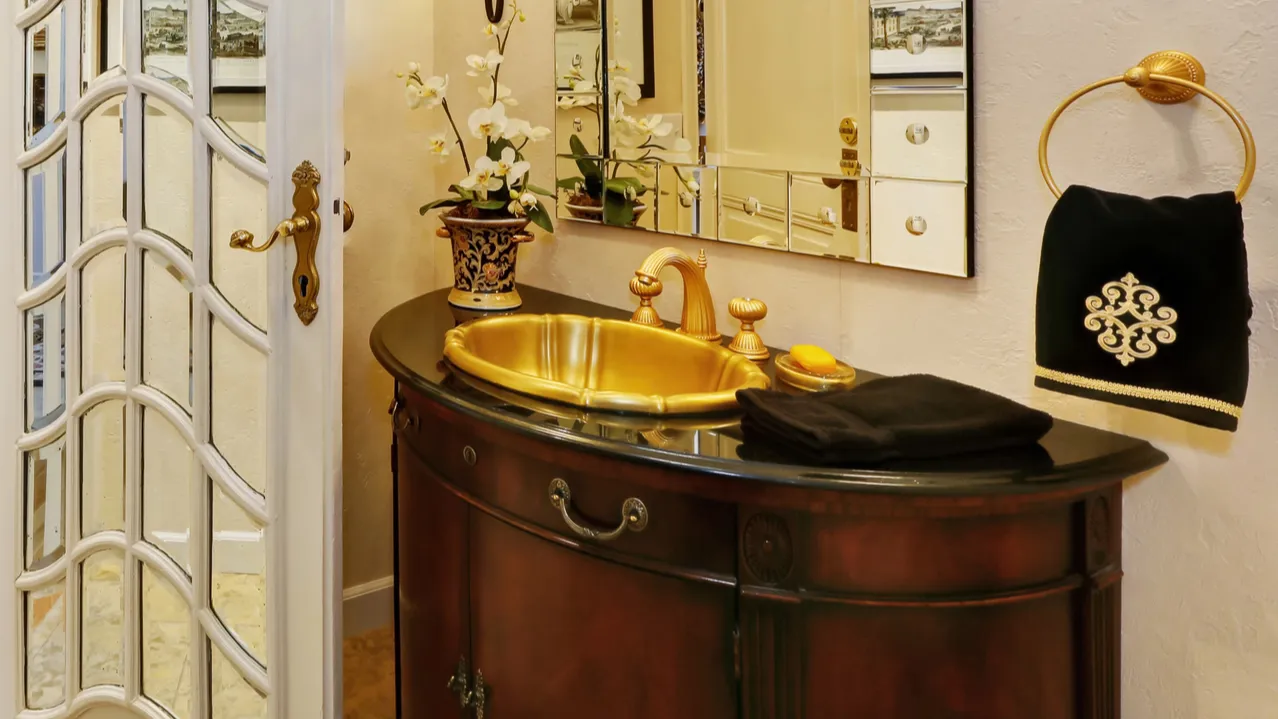 interior of luxury bathroom vanity with golden sink