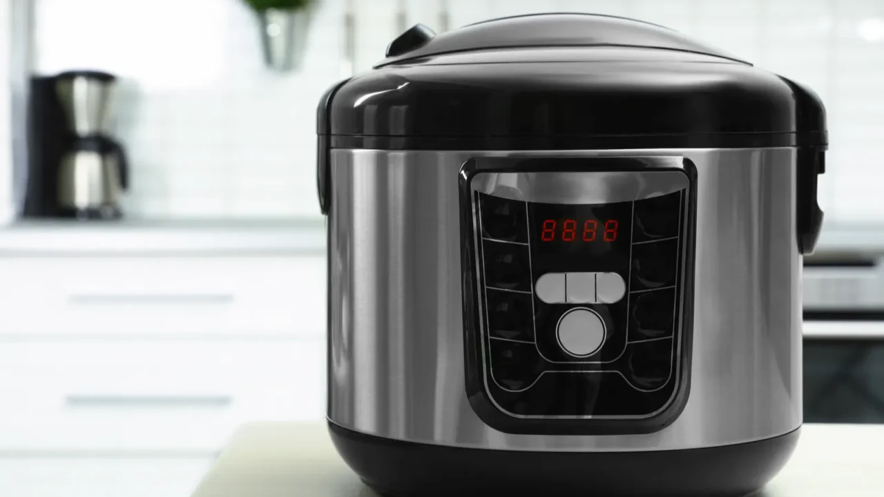 modern multi cooker on table in kitchen space for text