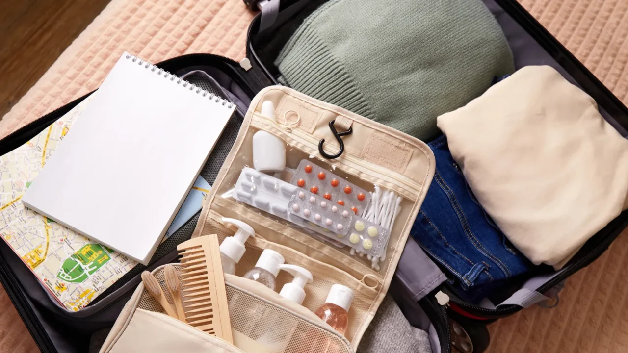 open suitcase packed with clothing toiletries and travel essentials ready